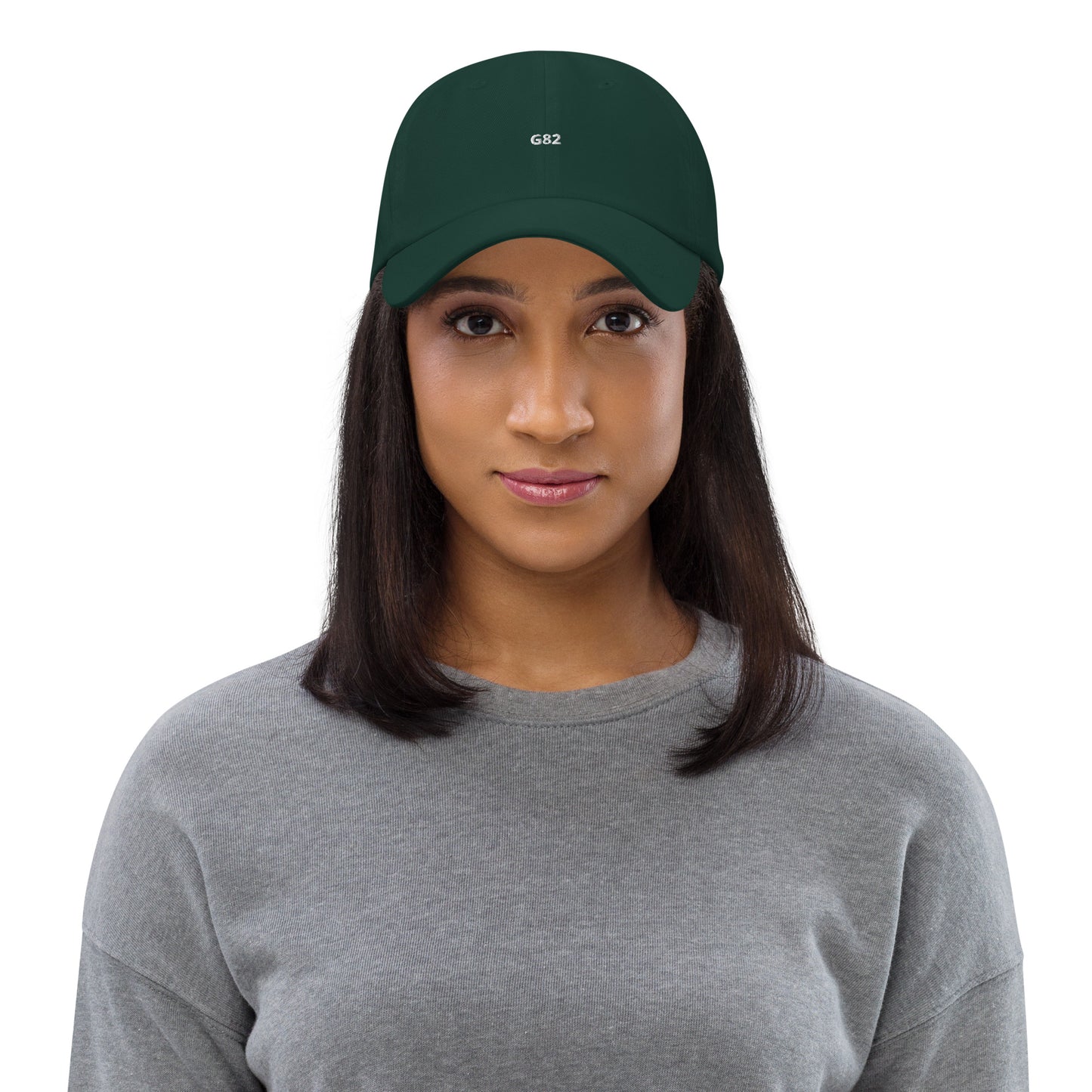 a woman wearing a grey shirt and a green hat