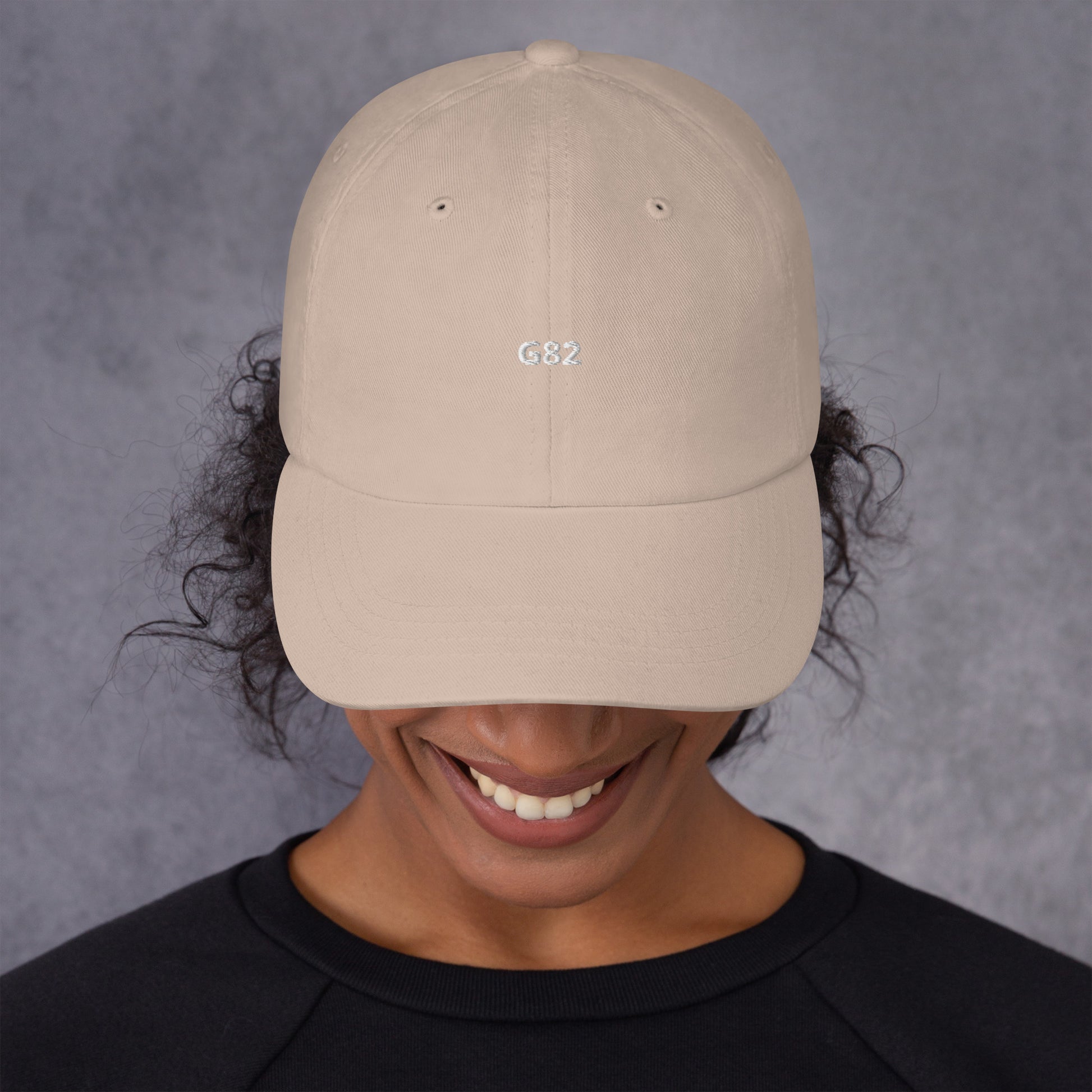 a woman wearing a hat with the BMW Chassis G82 embroidered on it